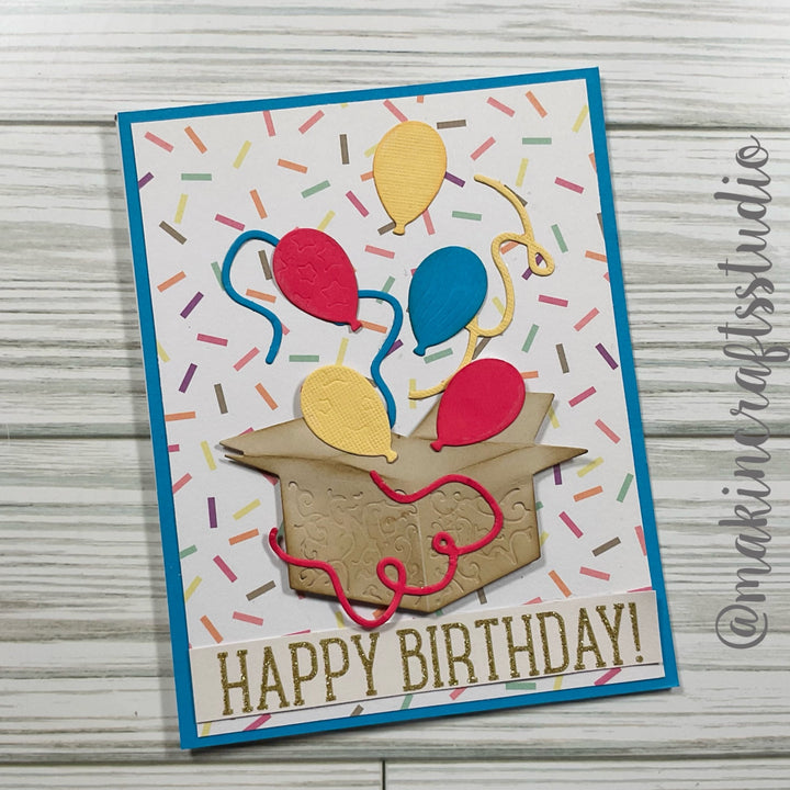 Kokorosa Metal Cutting Dies with Balloons Flying From Box