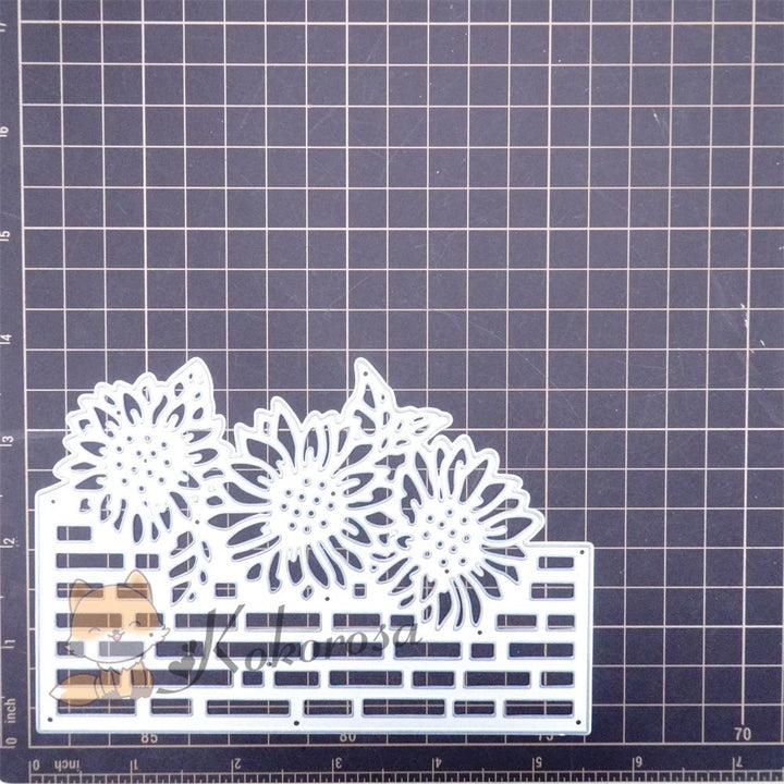 Kokorosa Metal Cutting Dies with Daisies on Brick Wall